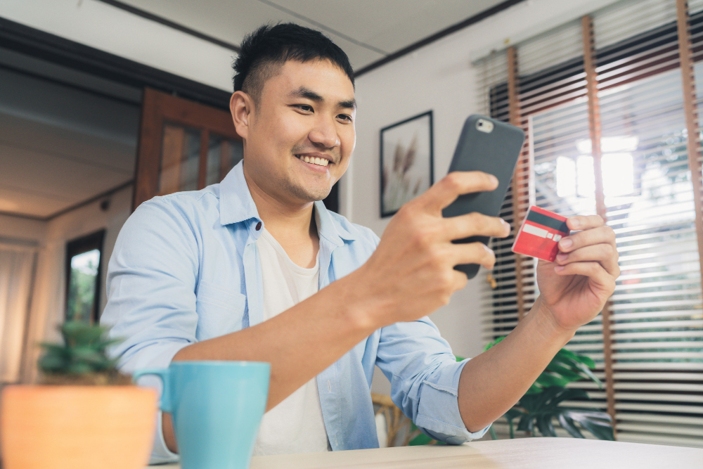 A man paying something with his card and smartphone