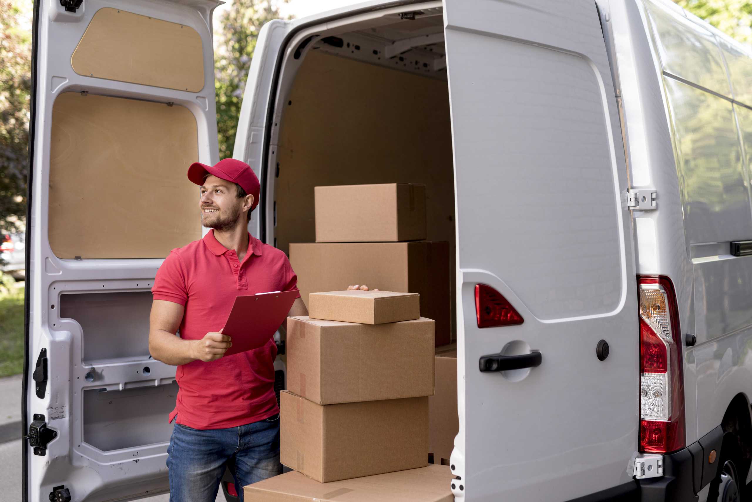 Delivery person loading a delivery van with parcels