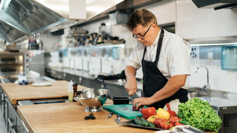 A chef slicing vegetables