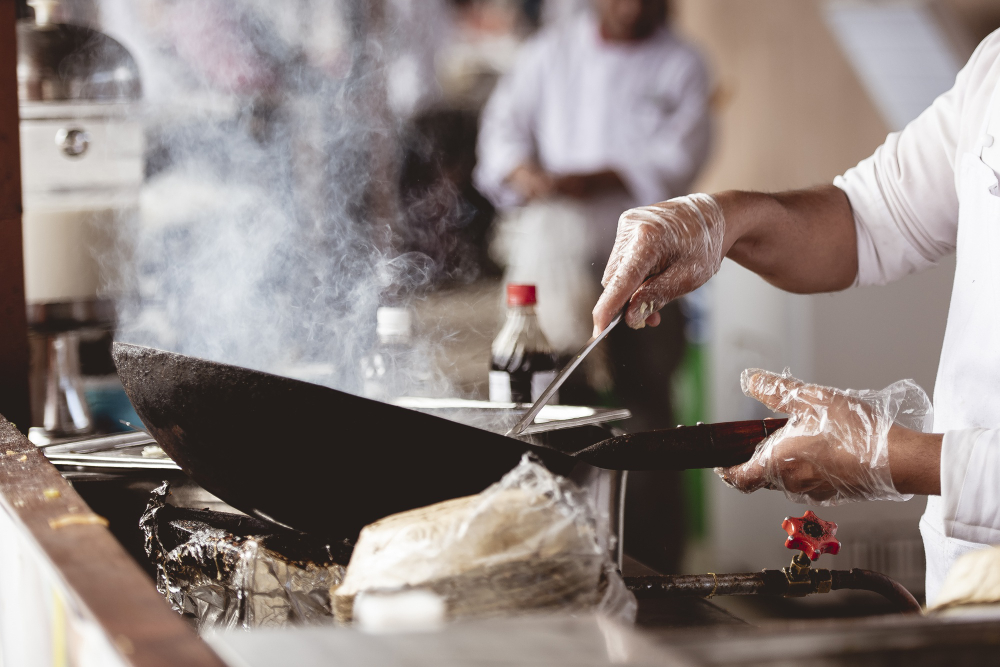 A chef using a wok to cook