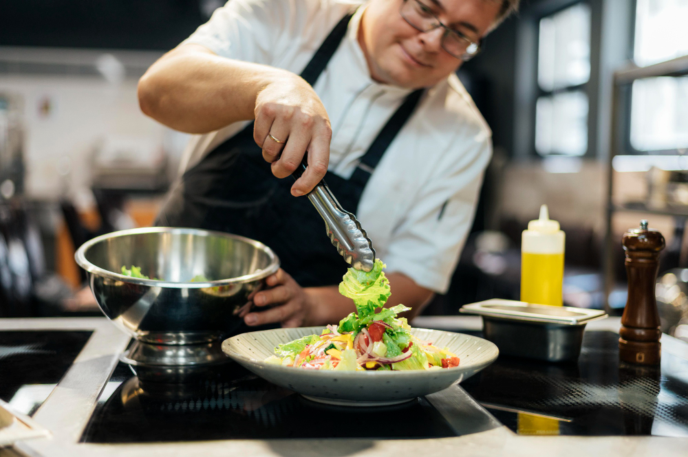 A chef finishing up a salad dish