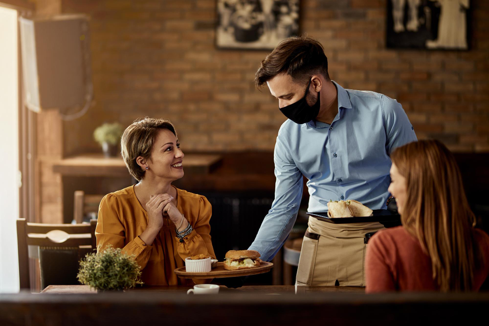 A waiter serving customers