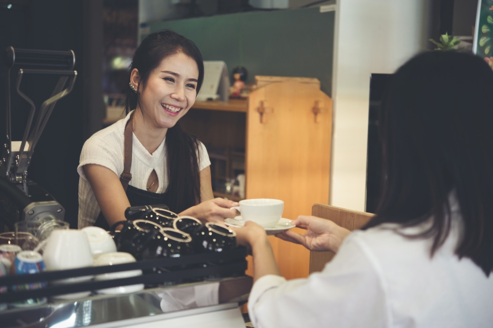 A worker serving coffee